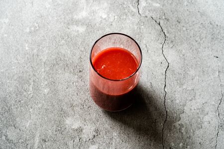 Healthy Organic Homemade Fresh Mixed Red Strawberry Smoothie with Banana, Grape, Apple and Orange in Glass. Ready to Drink.の写真素材