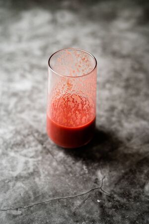 Healthy Organic Homemade Fresh Mixed Red Strawberry Smoothie with Banana, Grape, Apple and Orange in Glass. Ready to Drink.の写真素材