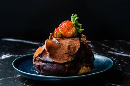 Turkish Dessert Polka Chocolate cake with Strawberry and White Cream from Local Patisserie in Plate for One Person Portion. Traditional Dessert.の写真素材