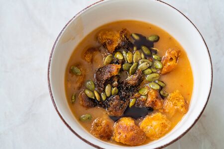 Homemade Butternut Squash Soup with Pumpkin Sauce, Pumpkin Seeds, Carrot and Crispy Croutons Bread. Organic Healthy Food.の写真素材