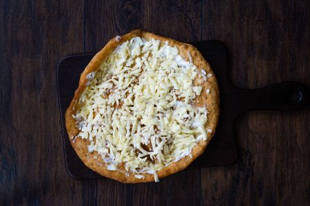 Traditional Langos / Langosh are originally Hungarian fried pancakes made from yeast dough, topped with Parmesan cheese and Mild Cream Cheese / Pisi. Ready to Eat.の写真素材