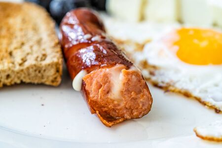 Bratwurst Sausage Filled with Emmental Cheese in Breakfast Plate. Fast Food.の写真素材