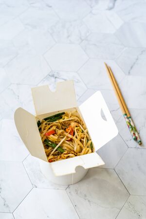 Take Away Asian Food Pad Thai Noodles with Shrimp and Crushed Peanuts in Plastic Box Package Container. Take Out. Ready to Eat.の写真素材