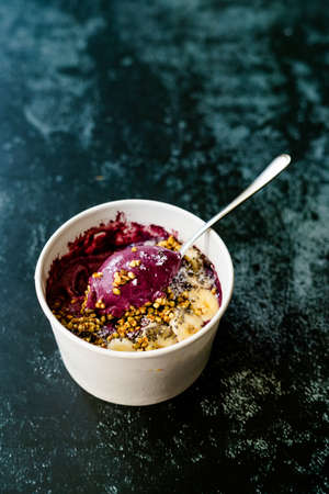 Take Away Vegan Food Acai Bowl with Almond Milk, Peanut Butter, Banana, Buckwheat Granola, Chia...