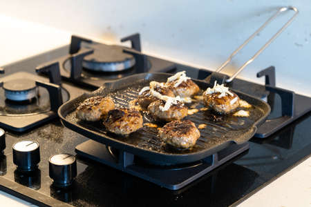 Cooking and Frying Meatballs in Pan / Turkish Kofte or kofta with Melted Cheese at Kitchen....