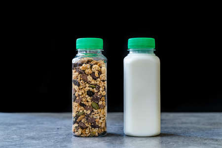 Roasted Granola in Plastic Bottle with Pumpkin Seeds, Chocolate Drops, Honey and Milk. Ready to Eat.の写真素材