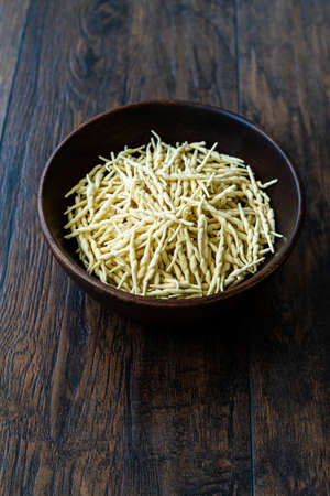 Fresh Trofie Raw Italian Pasta in Wooden Bowl. Ready to Cook.