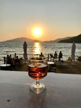 Glass of Liqueur Cocktail in Sunset. Ready to Drink for Summer.の写真素材