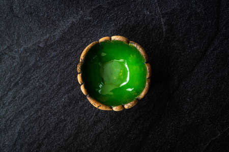 Handmade Ceramic Pottery Cup / Handcrafted Bowl on Dark Surface and Background. Ready to Use.の写真素材