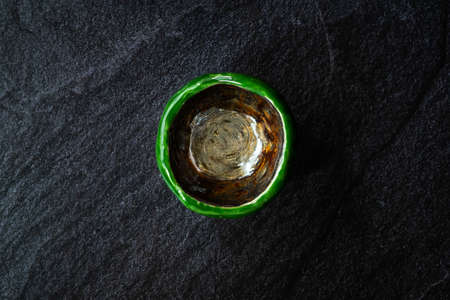 Handmade Ceramic Pottery Cup / Handcrafted Bowl on Dark Surface and Background. Ready to Use.の写真素材