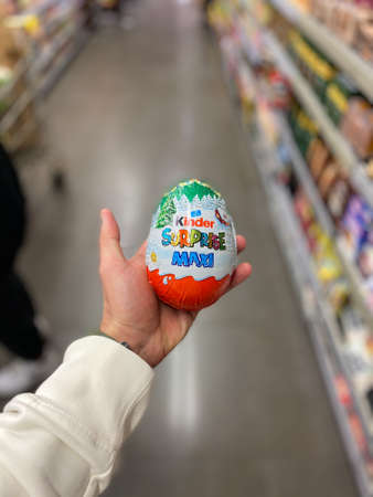 ISTANBUL, TURKEY - MAY 11 2019: Kinder Surprise Maxi Holding in Hand at Supermarket for Sale. Ready to Eat.のeditorial素材
