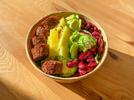 Healthy Food Bowl with Falafel, Pineapple, Mexican Red Kidney Beans and Brussel Sprouts in Plastic Bowl / Box or Container Package. Ready to Eat.の写真素材