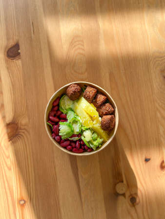 Healthy Food Bowl with Falafel, Pineapple, Mexican Red Kidney Beans and Brussel Sprouts in Plastic Bowl / Box or Container Package. Ready to Eat.の写真素材
