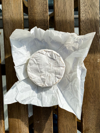 Brie Cheese on Wooden Table.の写真素材