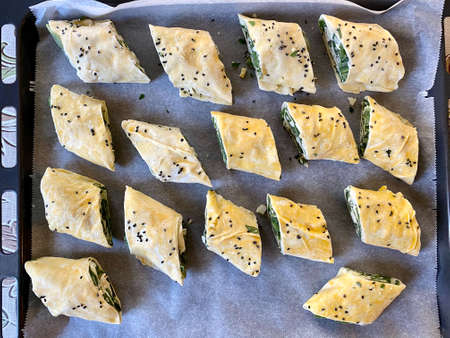Raw Pastry Puff Dough Rolled Turkish Borek or Burek with Cumin Seeds. Ready to Bake Oven Tray.