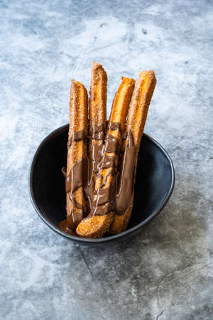 Churros Sticks with Chocolate Sauce. Fried Dough Pastry Traditional Spanish or Mexican Dessert....