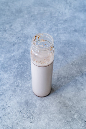 Take Away Homemade Almond Milk in Bottle with Vanilla Extract and Cinnamon Powder. Take Out. Ready to Drink.の写真素材