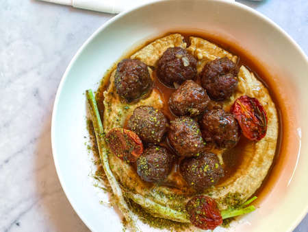 Spiced Lamb Meatballs with Hummus and Pistachio Powder served at Restaurant. Ready to Eat.の写真素材