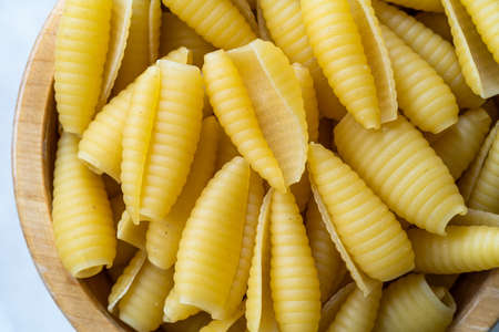Homemade Dry Organic Raw Cavatelli Pasta in Wooden Bowl. Ready to Cook.の写真素材