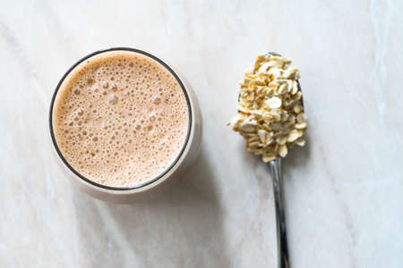 Oatmeal Smoothie with Peanut Butter, Cinnamon, Banana and Apple. Ready to Drink Organic Beverage.の写真素材