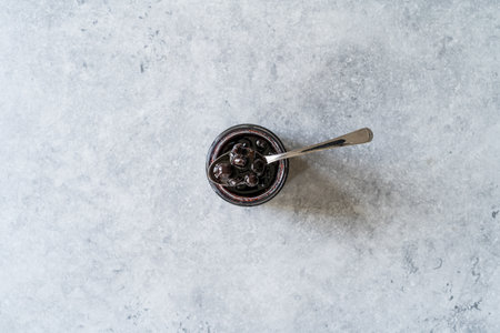 Organic Homemade Blueberry Huckleberry Jam Marmalade Preserves im Glass Bowl with Spoon. Organic Breakfast. food.の写真素材