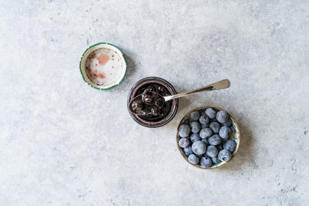 Organic Homemade Blueberry Huckleberry Jam Marmalade Preserves im Glass Bowl with Spoon. Organic Breakfast. food.の写真素材