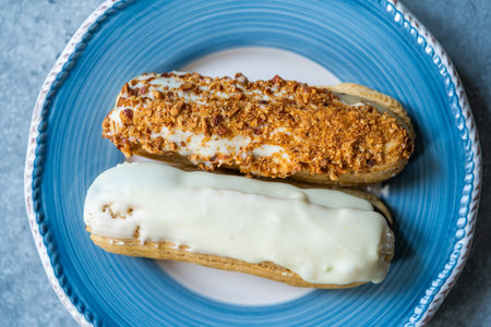 Group of Fench Delicious Dessert Eclairs in Plate. Traditional Dessert.