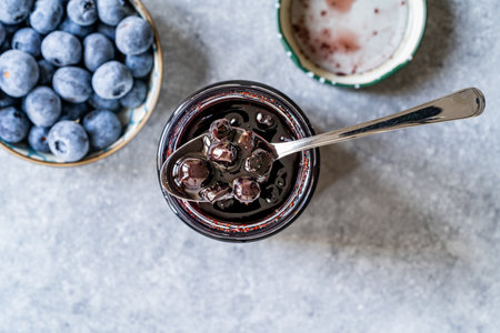 Organic Homemade Blueberry Huckleberry Jam Marmalade Preserves im Glass Bowl with Spoon. Organic Breakfast. food.の写真素材