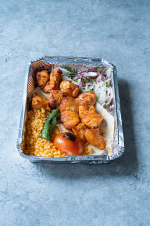 Take Away Turkish Chicken Kebab in Aluminum Foil Food Container. Take Out Dish. Ready to Eat and Serve.の写真素材