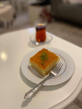 Turkish Dessert Revani Sweet Semolina Cake with Traditional Tea. Ready to Eat.の写真素材