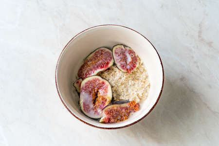 Muesli cereal mix with oatmeal, fig and almond milk. organic food for breakfastの写真素材