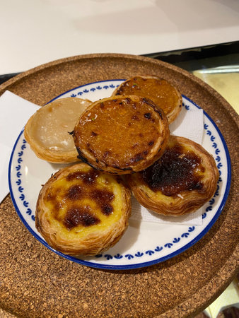 Portuguese Custard Tarts Pasteis de Nata. Pastel de Nata served with plate. Traditional Dessert.