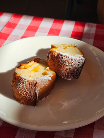 Peach Cake with Powdered Sugar served at Local Restaurant. ready to eat.