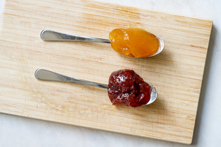 Spreadable Fruit with Mango, Raspberry, Pomegranate and Pineapple on Spoon. Ready to eat.