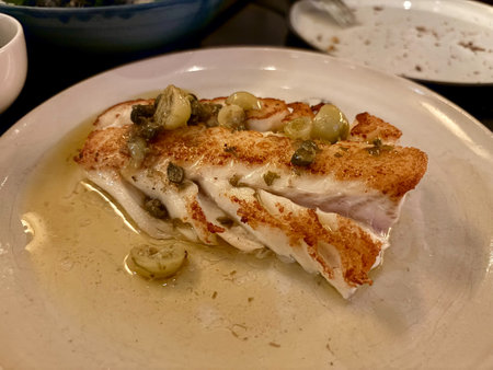 Fried fish fillet, Atlantic codfish with capers and green tomatoes. ready to eat.