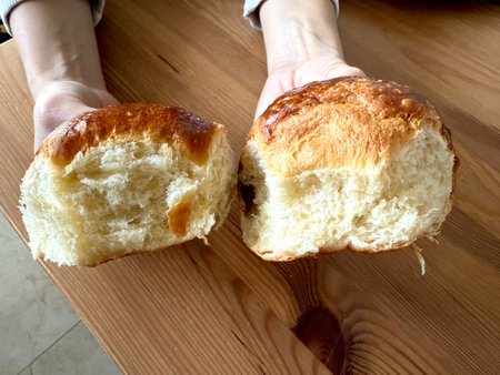 Brioche bread slice showcasing its soft, buttery texture, placed on a clean surface for a...
