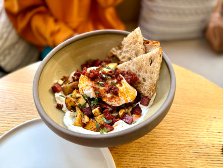 Traditional Turkish eggs Cilbir and fresh pita bread for traditional Turkish breakfast served on...
