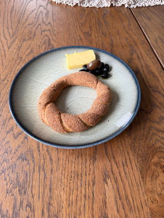 Wheat bran bagel with cheese and olives for diet and breakfast on wooden table