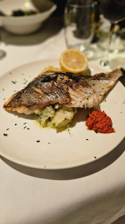 Appetizing fried dorado fish. Restaurant menu, dieting, cookbook recipe top view. Ready to eatの写真素材