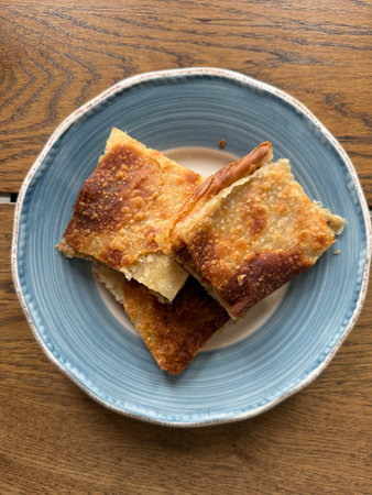 Homemade Alt upper boregi or Rumeli Borek on wooden table ready to eat