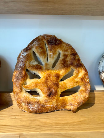 Fougasse bread with olives at bakery shop for sale