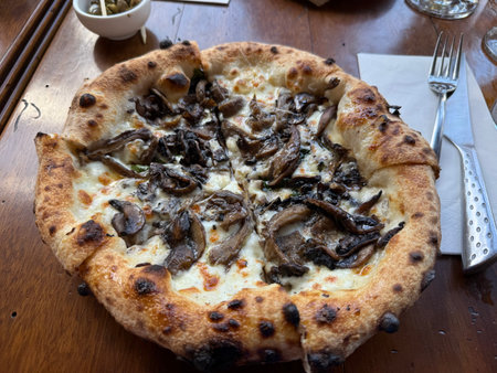 Mushroom pizza served at restaurant on table ready to eat