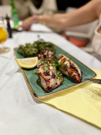 Baked squid stuffed with onions, carrots, mushrooms and rice