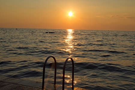 Ladder at the Adriatic Sea at sunsetの写真素材