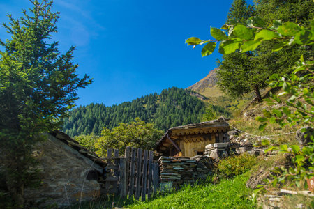 Old wooden house in the mountains on a background of blue sky.の写真素材
