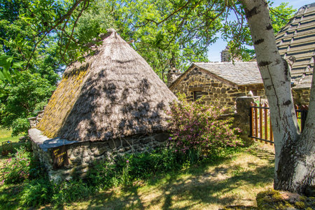 Old wooden house with thatched roof in the countryside of Scotland.の写真素材