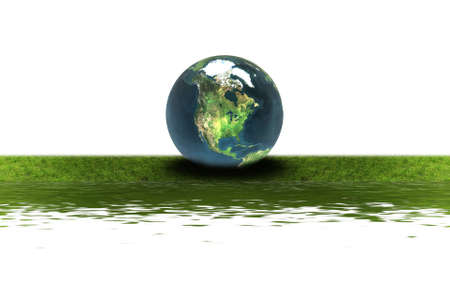 earth on the green grass isolated on a whiteの写真素材