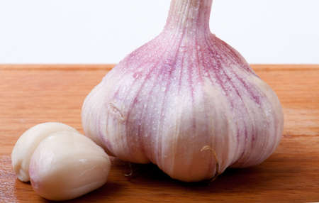 garlic on a wooden cutting boardの写真素材