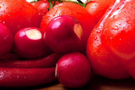 red only vegetables on a wooden cutting boardの写真素材