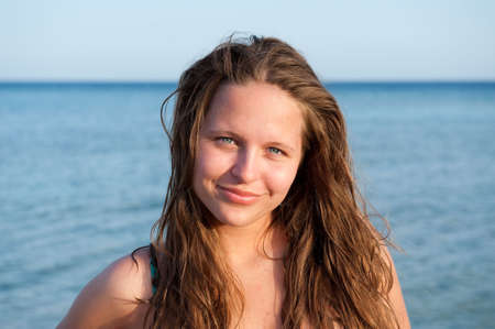 pretty young girl at sea on the beachの写真素材